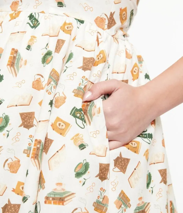 Retrolicious 1950s Cream Book and Tea Print Cotton Swing Dress Dresses Unique Vintage Pocket Dresses